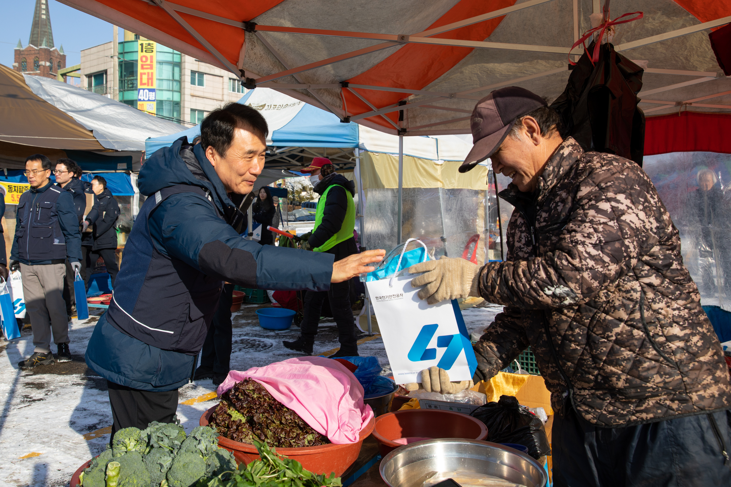 한국전기안전공사 남화영 사장(왼쪽)이 시장 상인들에게 전기안전요령을 설명하며 홍보물품을 나누어주고 있다. 사진제공=한국전기안전공사