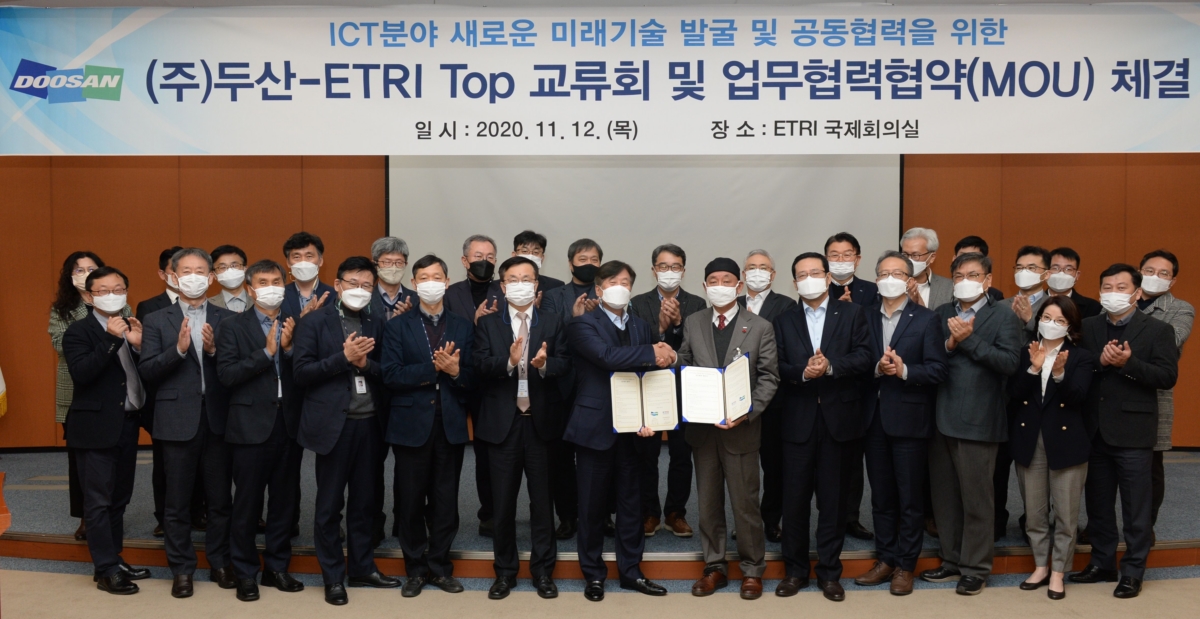 지난 12일 한국전자통신연구원(ETRI) 대전본원에서 열린 ㈜두산과 ETRI의 ‘ICT 분야 미래기술 발굴 및 협력’ 협약식에서 동현수 ㈜두산 부회장과 김명준 ETRI 원장을 비롯한 두 기관의 임직원들이 협약식을 마치고 기념촬영을 하고 있다.