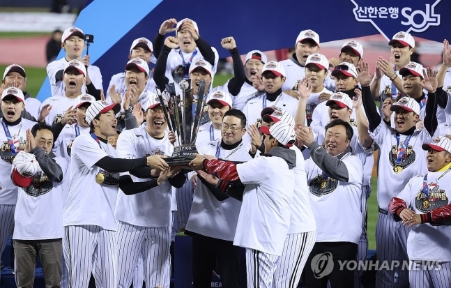 (사진=연합뉴스) 29년 만에 한국시리즈 우승을 확정한 LG 구광모 회장과 김현수 등이 우승 트로피를 들어 올리고 있다