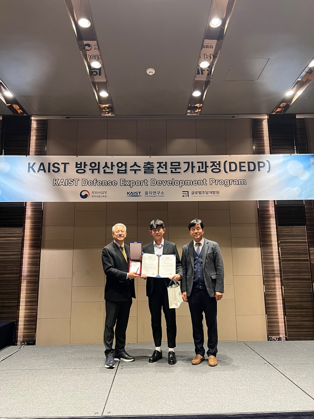 (왼쪽) 김만기 KAIST 교수와 정재원 KAIST 을지연구소장이 22일 롯데시티호텔 대전에서 DEDP 4기 대표 수강생에게 수료증을 수여하고 기념 사진을 촬영하는 모습 (KAIST 을지연구소 제공)